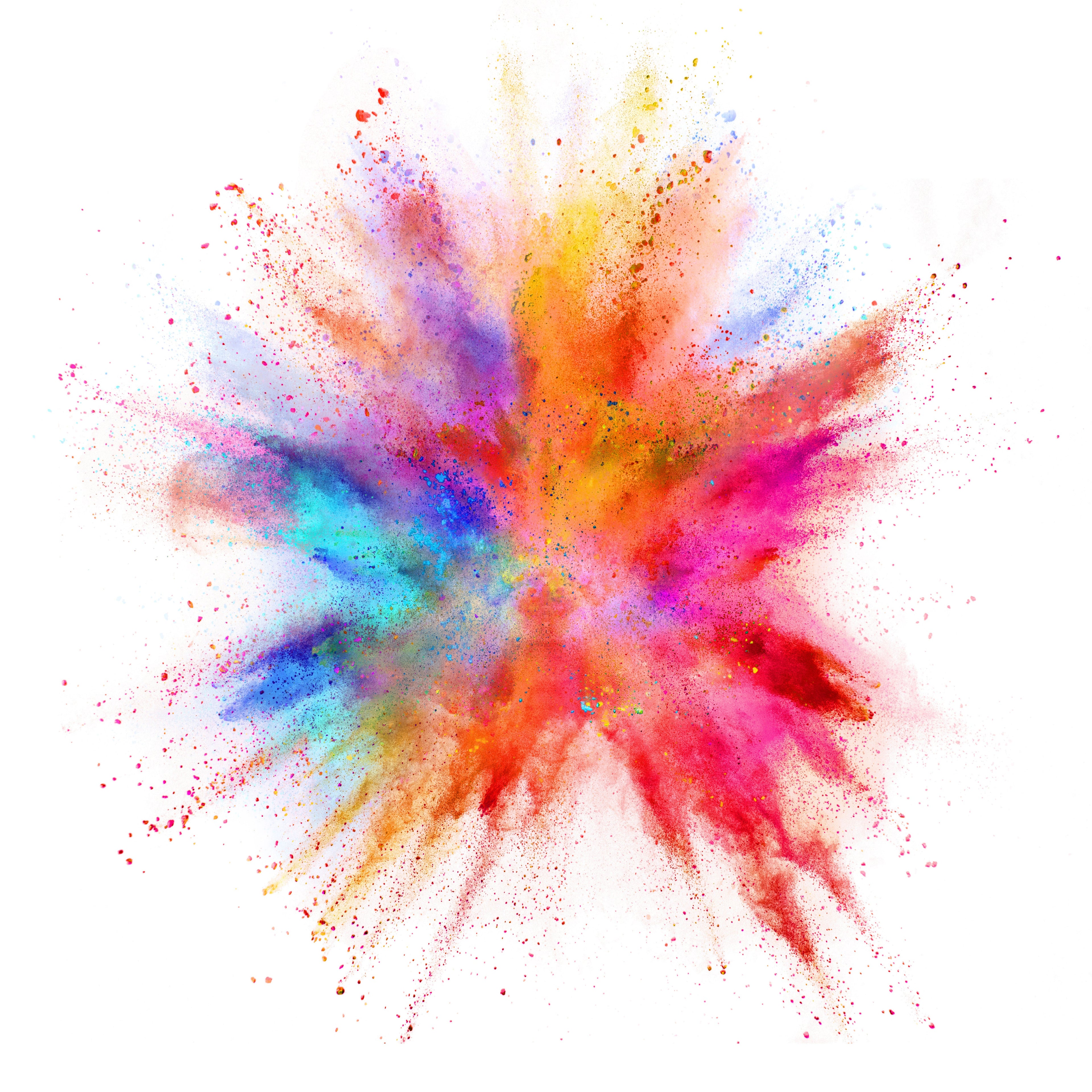 A vibrant burst of multicolored powder exploding in a starburst pattern on a solid white background.